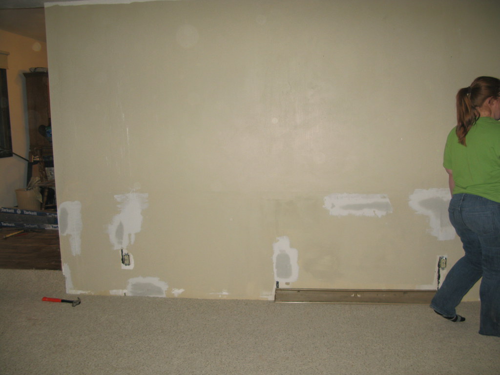 Filling cracks and holes, applying putty, and sanding surfaces.